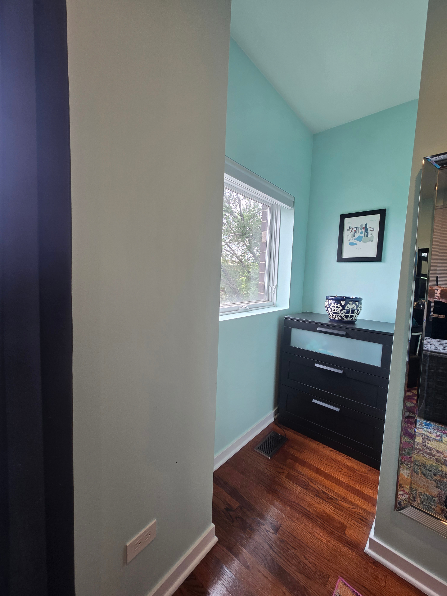 Primary bedroom dressing nook with vaulted ceiling and full-length mirror