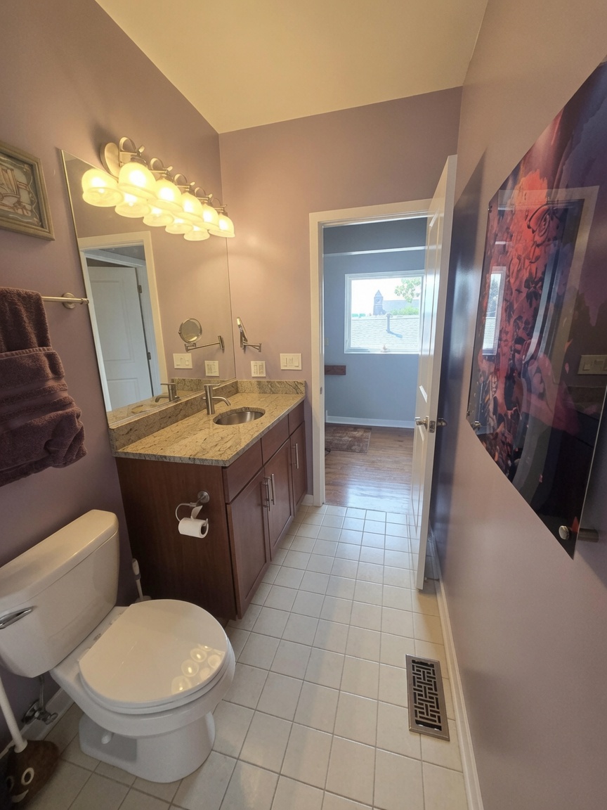 Guest bath granite vanity with brushed nickel fixtures