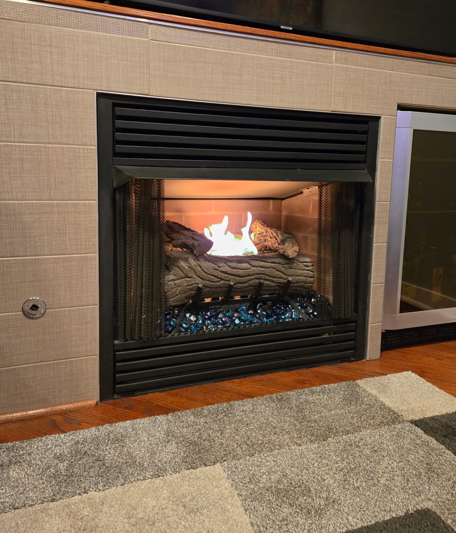 In-unit gas fireplace with blue fire glass